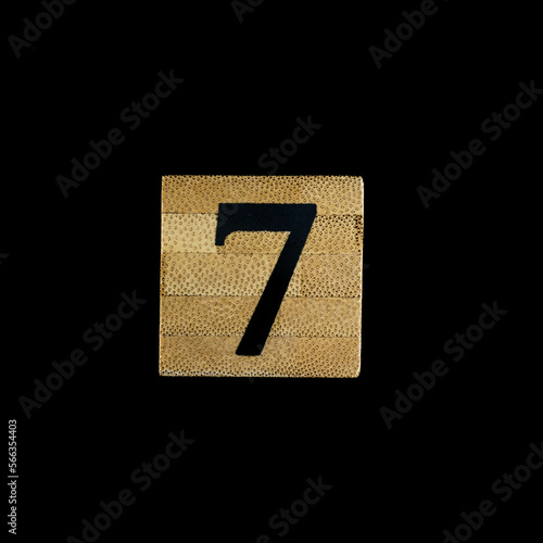 number 7 seven wooden isolated on black background.