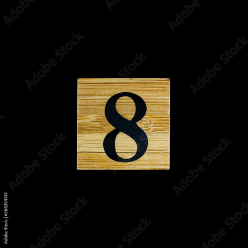 number 8 eight wooden isolated on black background.