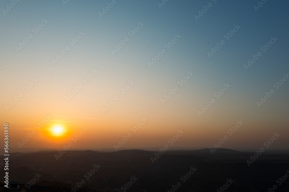 beautiful foggy landscape with mountains peak and sunset sky