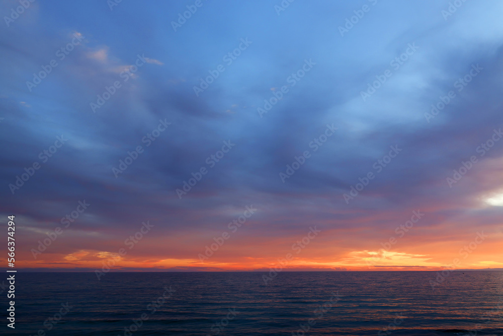 Sunset sky clouds over the sea in Apulia, Italy. Beautiful sunlight in the sea. Amazing nature landscape seascape Colorful sky clouds background.	