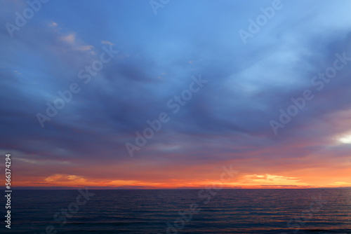 Sunset sky clouds over the sea in Apulia, Italy. Beautiful sunlight in the sea. Amazing nature landscape seascape Colorful sky clouds background. 