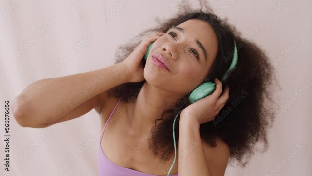 Young cheerful woman wearing headphones in studio. Young cheerful woman wearing headphones in studio.