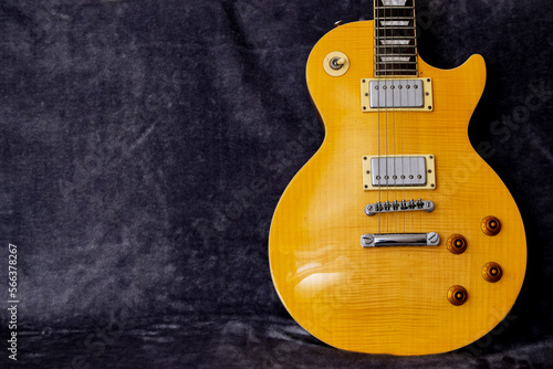 Yellow Les Paul electric guitar on a fur background photo