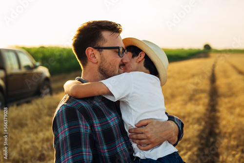 Father and son hug in the fields