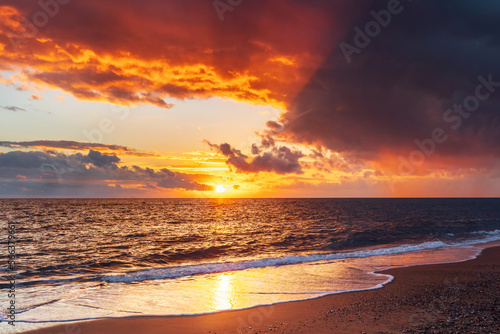 Beautiful bright sunset on the background of the Mediterranean beach. Natural background, tourism travel holidays. © Anna