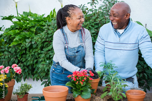 A senior couple doing a gardening activity at home to enjoy their retirement. Concept: gardening, senior couple, hobby