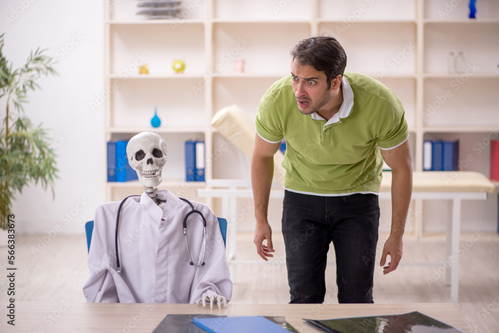 Young male patient visiting skeleton doctor Young male patient visiting skeleton doctor