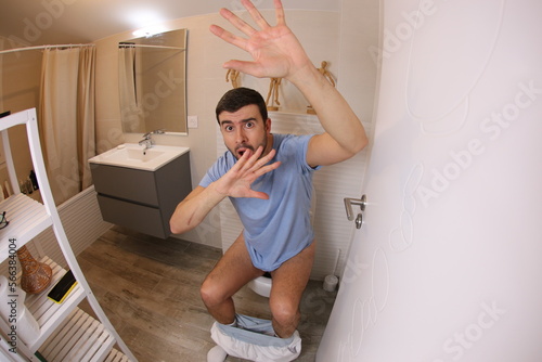 Embarrassed man caught in the toilet  photo
