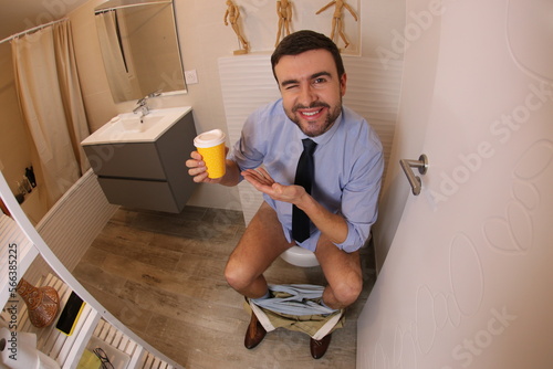 Businessman drinking coffee for constipation relief 