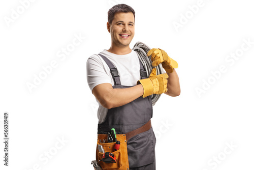 Young electrician carrying cables on shoulder