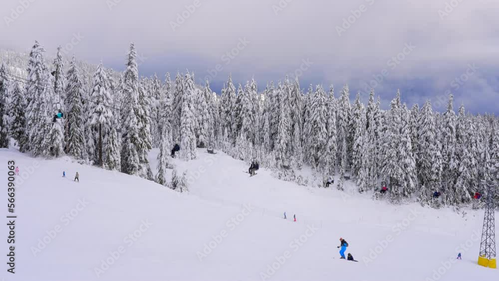 Establishing shot of ski resort in slow motion at winter in Vancouver, Canada, North America. Day time on January 2023. Still camera. Establishing shot of ski resort in slow motion at winter in Vancouver, Canada, North America. Day time on January 2023. Still camera.