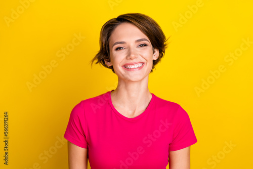 Photo of sweet positive woman dressed pink t-shirt smiling showing white teeth isolated yellow color background