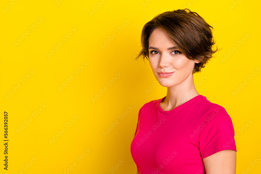 Photo of adorable lady wear bright clothes stand near empty blank space banner ad isolated on yellow color background