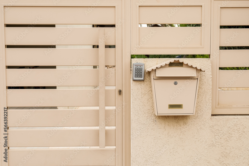 Modern fence with intercom and mailbox outdoors Modern fence with intercom and mailbox outdoors