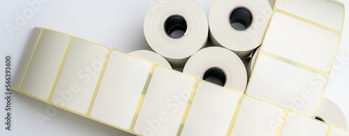 Rolls of white labels isolated. Labels for direct thermal or thermal transfer printing. Blank sticky label roll for thermal transfer printing pirce criss.	 photo