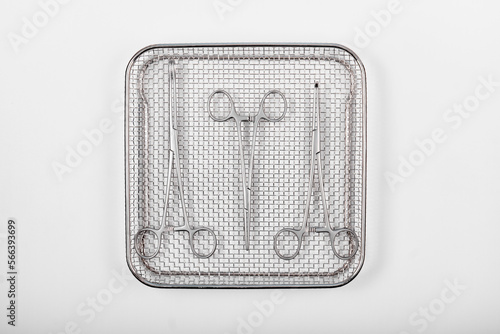 Surgical instruments in a tray on a white