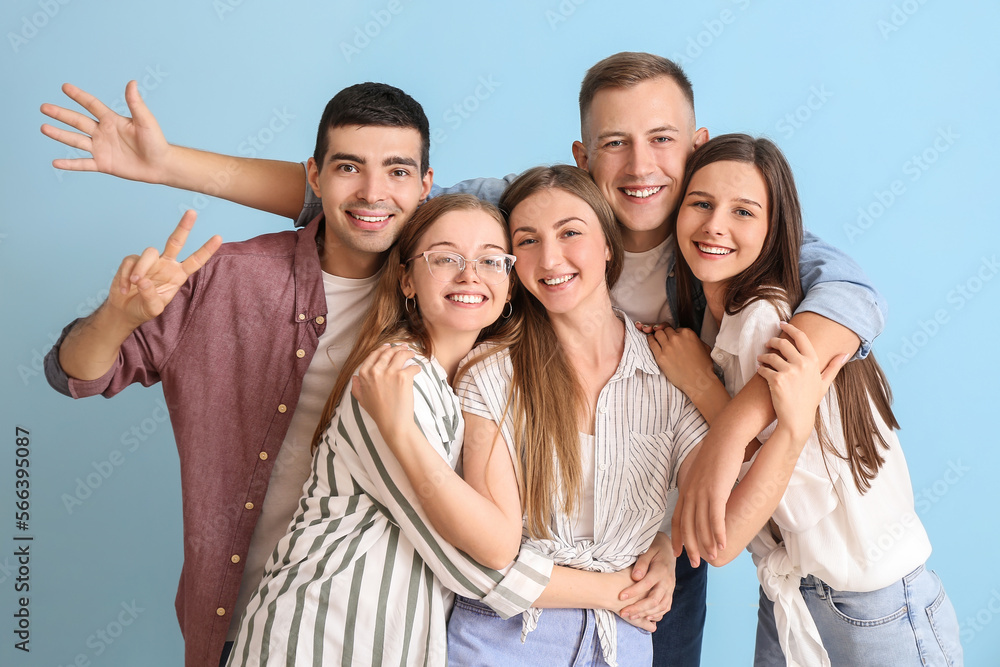 Group of happy friends hugging on blue background Group of happy friends hugging on blue background