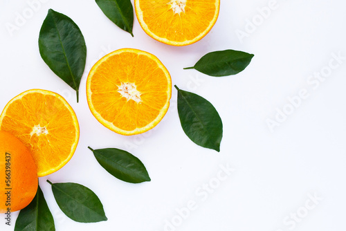 Orange fruit with green leaves on white background.