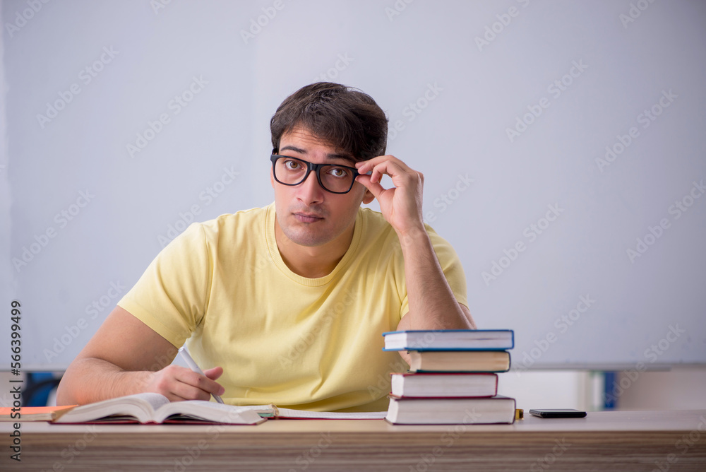 Young male student sitting in the classroom Young male student sitting in the classroom
