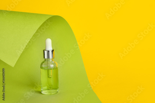 Bottle of healthy serum on color background