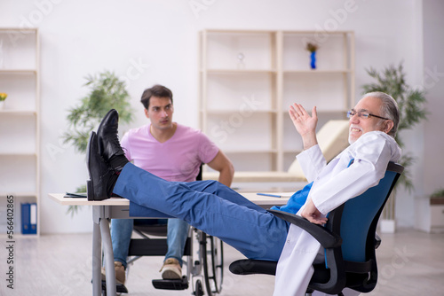 Young patient in wheelchair visiting old doctor