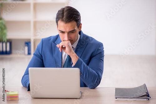 Young male employee working in the office