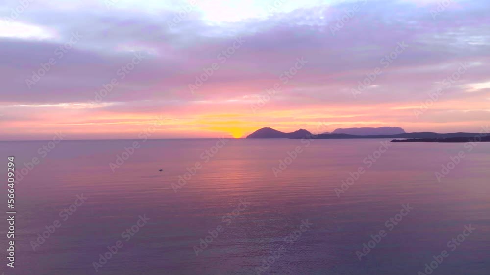Stunning orange sunrise over calm sea with islands and beaches Stunning orange sunrise over calm sea with islands and beaches