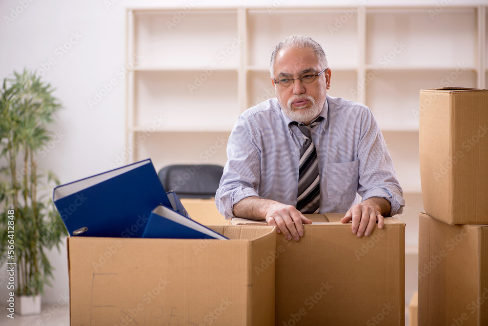 Old male employee in office relocation concept Old male employee in office relocation concept