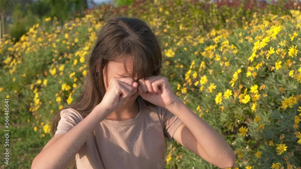 Seasonal allergies. A teenage girl in a spring park rubs her eyes from pollen. Seasonal allergies. A teenage girl in a spring park rubs her eyes from pollen.