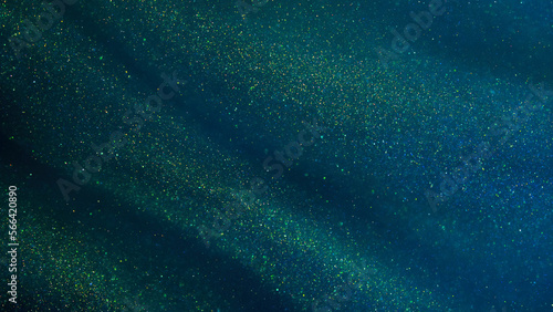 Abstract galaxy background. Golden glitter particles on a dark green background with blue hues. Golden dust particles magical stains.