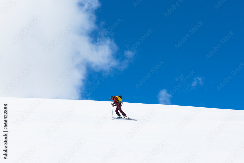 Sky and clouds over person skiing alone on snowcapped hill, Leadville, Colorado, USA Sky and clouds over person skiing alone on snowcapped hill, Leadville, Colorado, USA