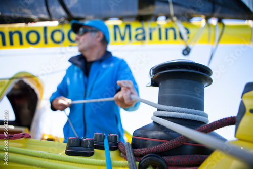Senior man pulling rope at sailboat, La Trinite-sur-Mer, Morbihan, France