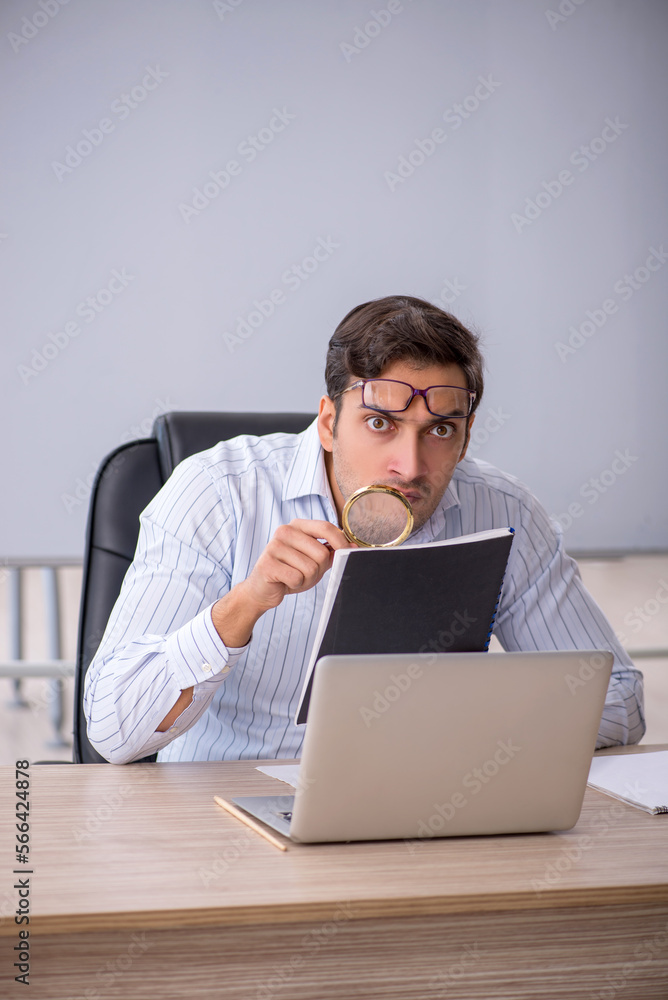 Young male teacher sitting in the classroom Young male teacher sitting in the classroom