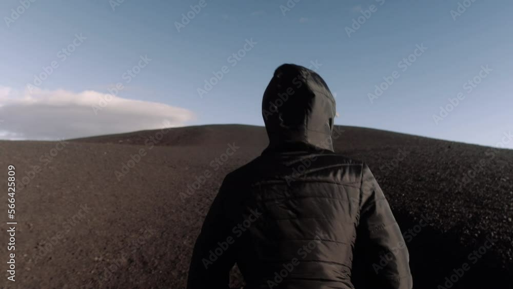 Young woman walking in the desert Craters of the moon volcano Young woman walking in the desert Craters of the moon volcano