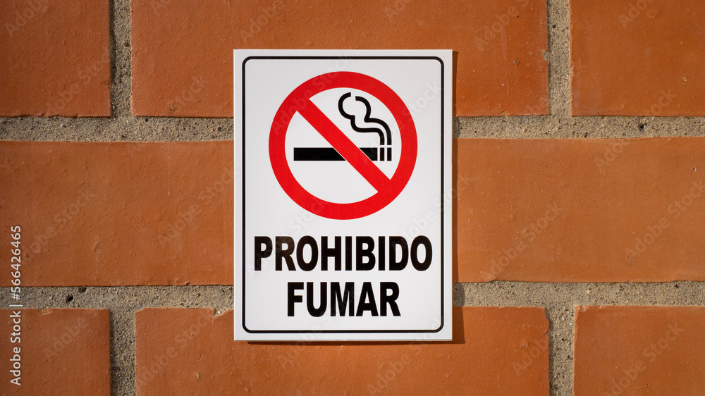 No smoke sign on brick wall in Spanish No smoke sign on brick wall in Spanish