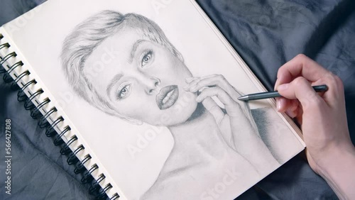 Footage of a female artist drawing a portrait of a woman. Close-up of portraying a beautiful young girl. High quality 4k footage
