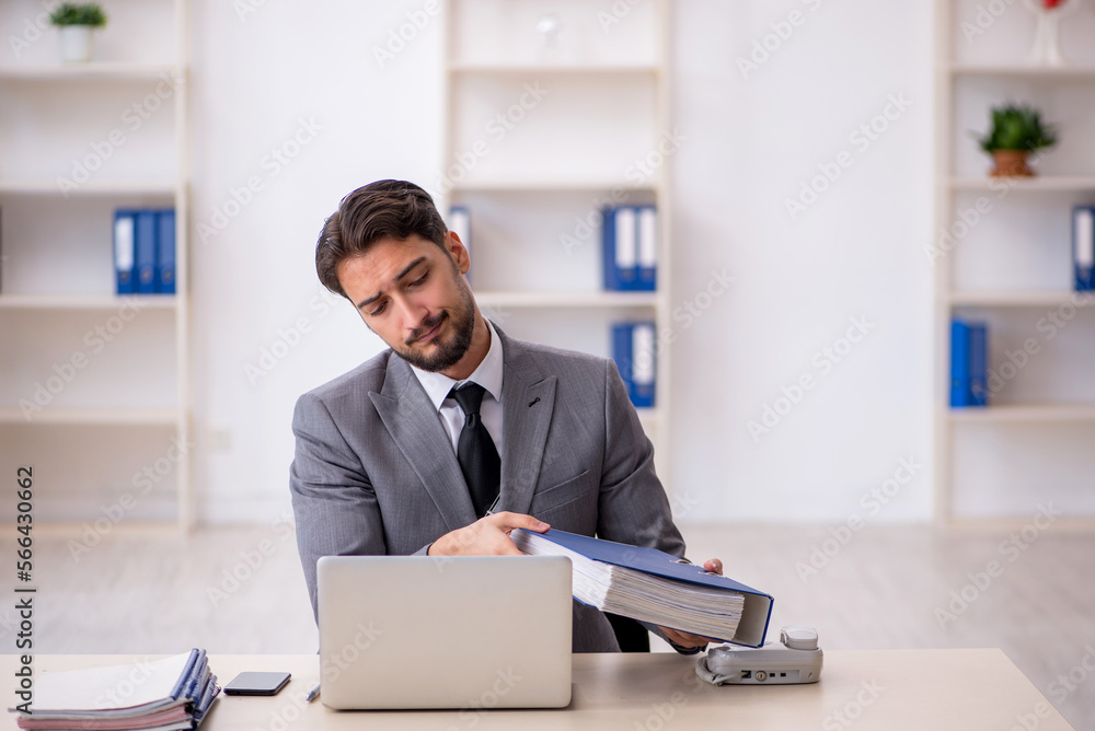 Young male employee working in the office Young male employee working in the office