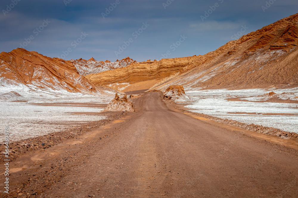 Dirt road in Moon Valley dramatic landscape at Sunset, Atacama Desert, Chile