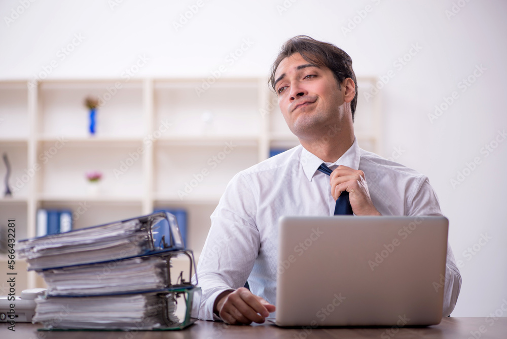 Young male employee working in the office Young male employee working in the office
