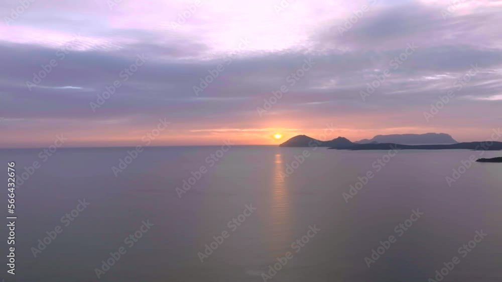 Stunning orange sunrise over calm sea with islands and beaches Stunning orange sunrise over calm sea with islands and beaches