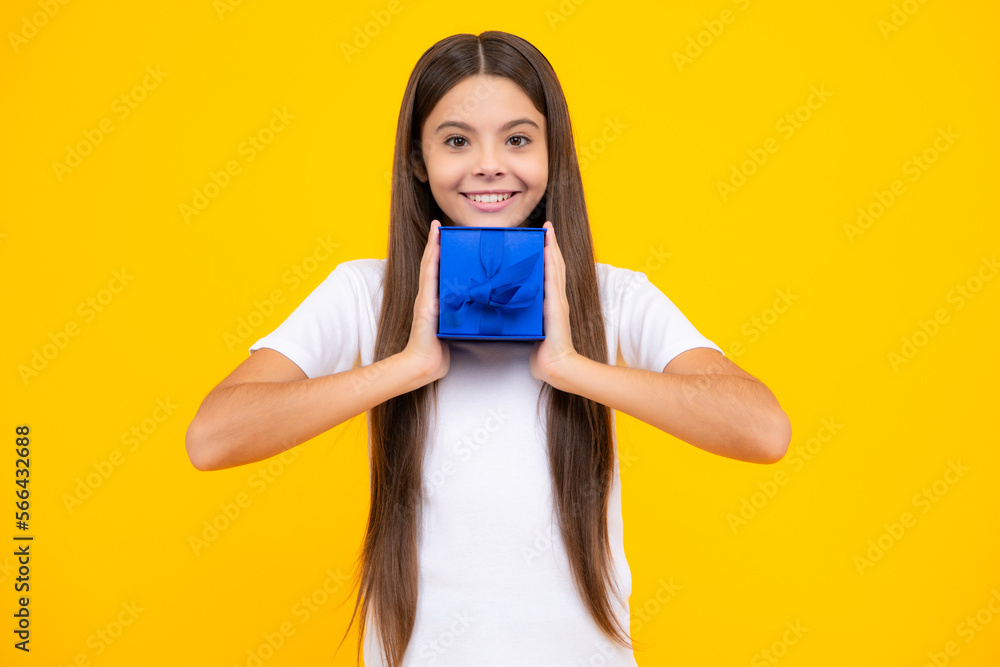 Happy teenager portrait. Child teen girl 12-14 years old with gift on isolated background. Birthday, holiday concept. Teenager hold present box. Smiling girl. Happy teenager portrait. Child teen girl 12-14 years old with gift on isolated background. Birthday, holiday concept. Teenager hold present box. Smiling girl.