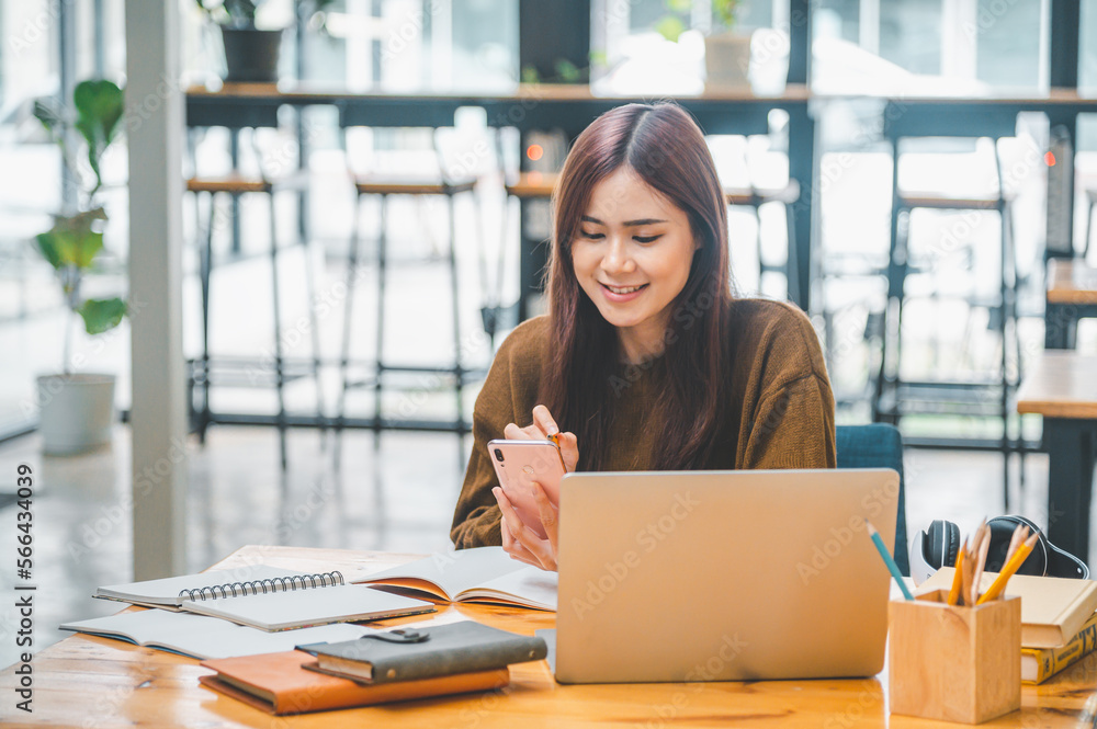 young student wearing headphones studies online, distance learning, and keeps up to date on the global coronavirus pandemic..