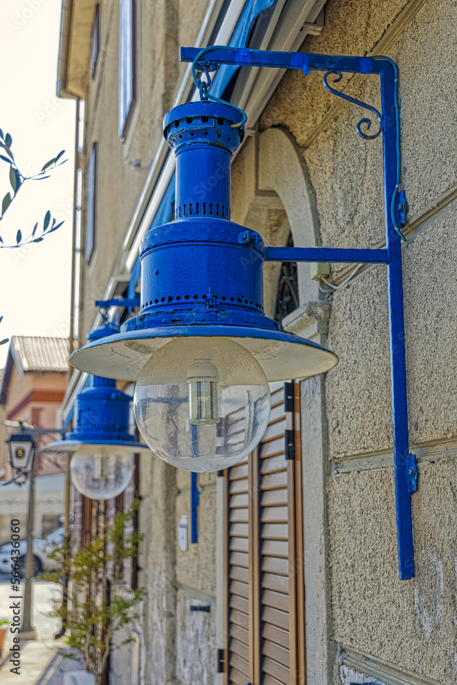 Blue electric lamps at the old house in Cres town port