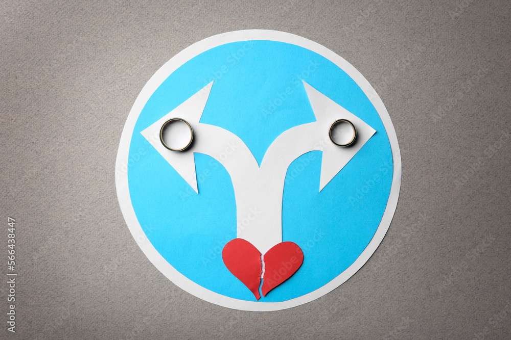 Divorce concept. Paper heart, arrows and rings on light grey background, flat lay Divorce concept. Paper heart, arrows and rings on light grey background, flat lay