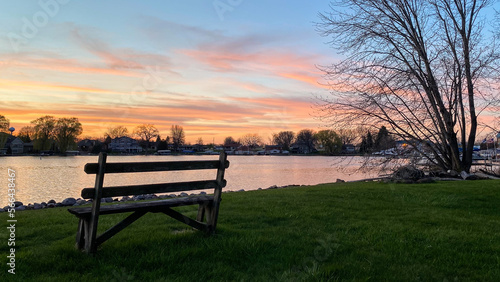 bench by the river channel at sunset