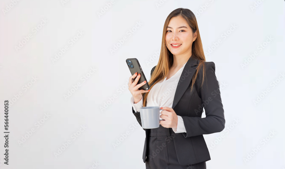 Asian businesswoman,Happy Asian woman texting on a phone and hot drink standing isolated over white background Asian businesswoman,Happy Asian woman texting on a phone and hot drink standing isolated over white background