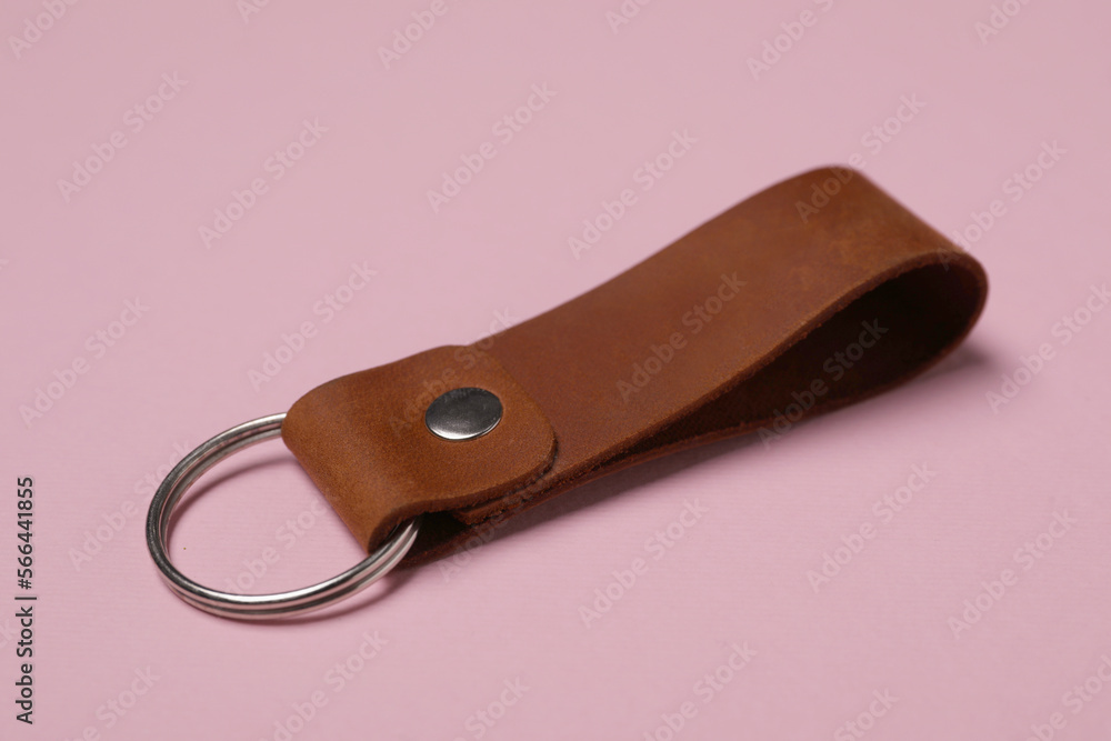 Leather keychain with Ukrainian coat of arms on pale pink background Leather keychain with Ukrainian coat of arms on pale pink background
