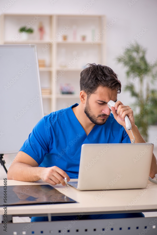 Young male doctor in telemedicine concept Young male doctor in telemedicine concept