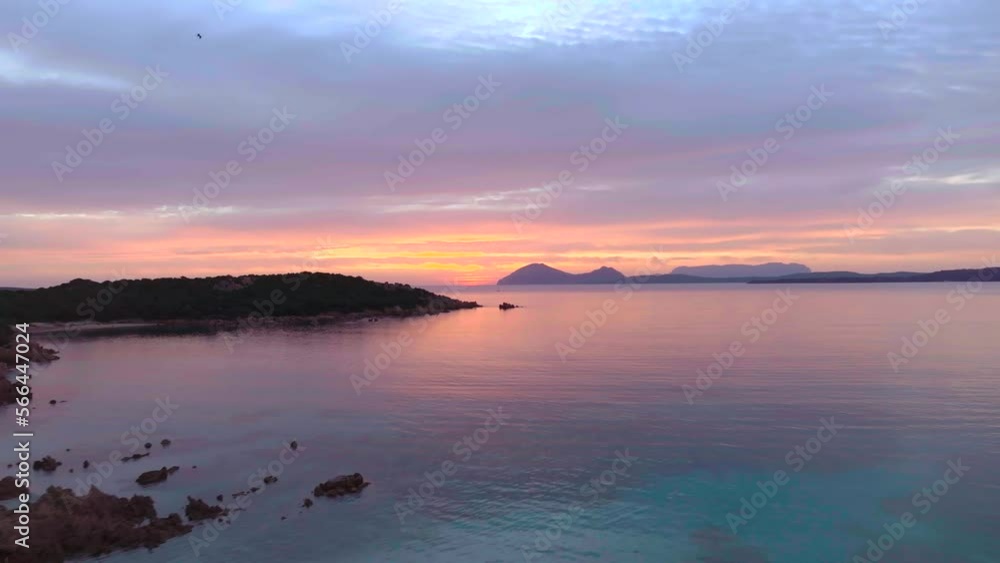 Stunning orange sunrise over calm sea with islands and beaches Stunning orange sunrise over calm sea with islands and beaches