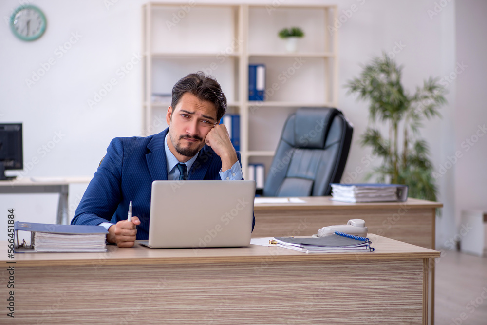 Young male employee working in the office Young male employee working in the office